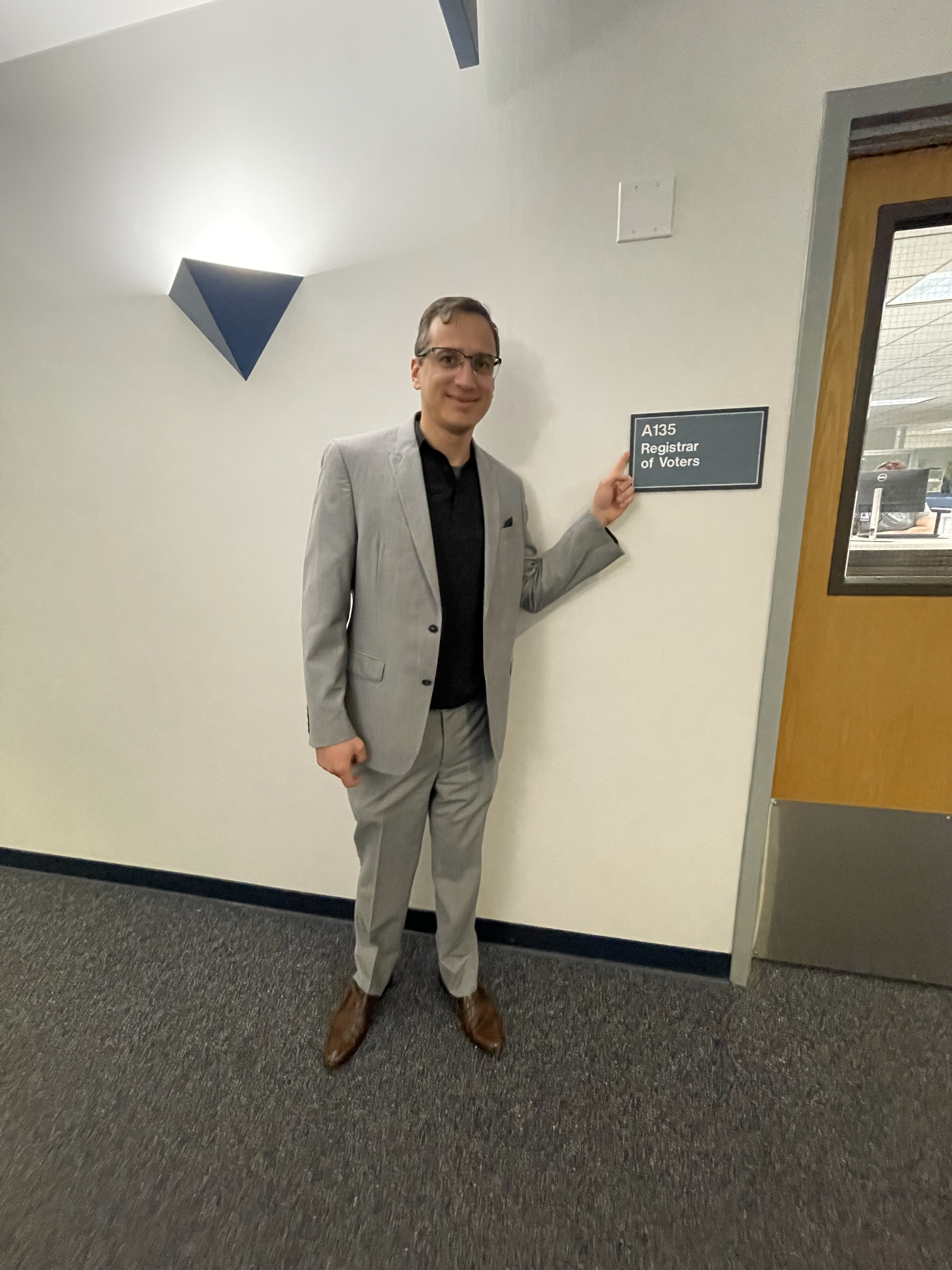 Josh Cole in front of the Registrar of Voters office